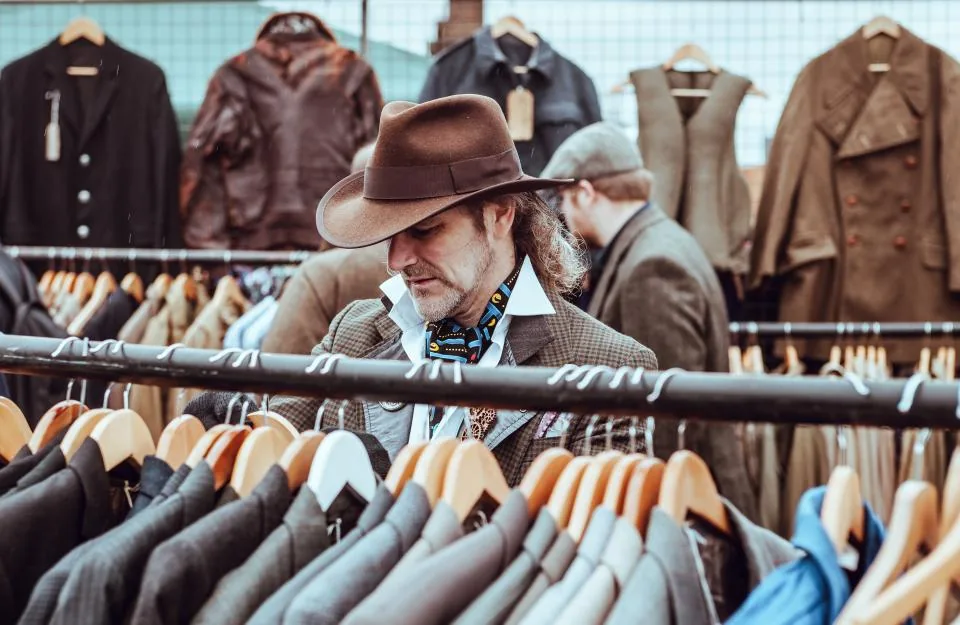 Customer browsing jackets on a clothing rack